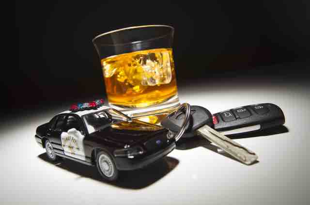 Car Keys, Small Police Car And A Glass Of Alcohol